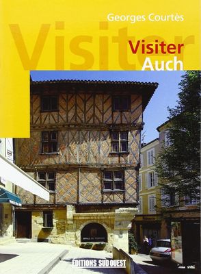 a yellow book cover with a picture of a building in the background