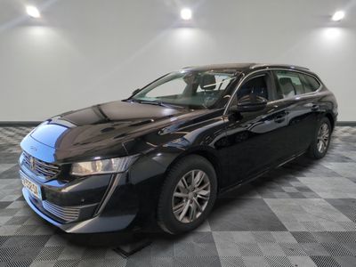 a picture of a black car parked in a showroom