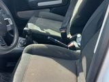 the interior of a car with a steering wheel and a seat belt