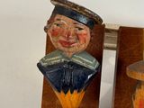 two wooden figurines of a man and a woman