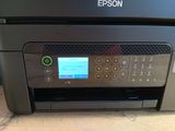 a close up of a printer on a table with a keyboard