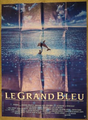 a movie poster for le grand bleu with a dolphin jumping out of the water