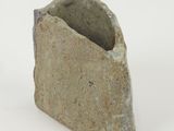 a piece of stone that is sitting on a white surface