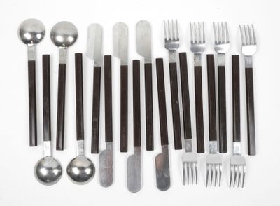 a lot of forks, spoons, and spoons on the table