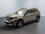 the silver suv is parked in a room with a black floor