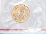 a gold coin in a clear plastic bag on a white background