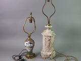 pair of antique lamps on a table with a lamp on top of them