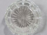 a clear glass bowl with a circular design on it