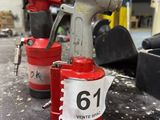 two red fire hydrants sitting next to each other on a table
