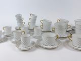 a lot of cups and saucers that are sitting on a table