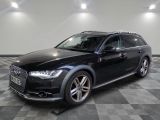 an image of a black audi suv parked in a garage