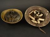 pair of helmets and a bowl on a black surface