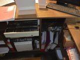 a desk with a computer, keyboard, mouse, and other items on it