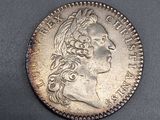 une pièce d'argent portant une tête de femme