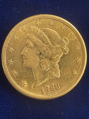 a close up of a gold coin on a blue surface