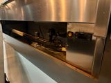 a large stainless steel oven with a bunch of wires in it