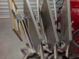 a lot of knives that are sitting on the back of a red car