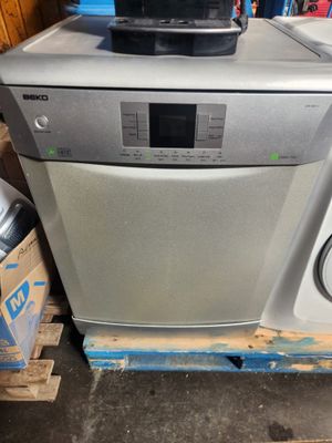 an image of a silver dishwasher sitting on top of a wooden pallet