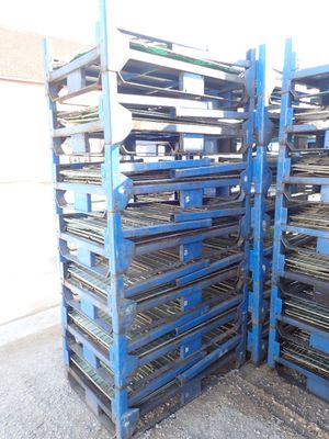 many trays of food that are on a blue rack