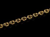 a close up of a gold chain on a black background