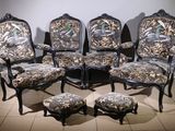 a group of chairs and a ottoman in a room