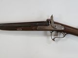 an old gun that is on display on a white surface