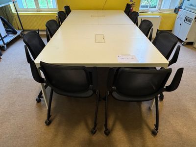 a long table with chairs around it in a room