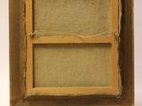 an old wooden easel with a piece of fabric on top of it