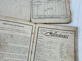 several old papers are sitting on top of a white table