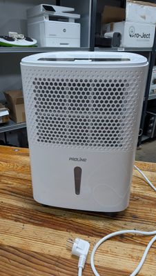 a white air purifier sitting on a wooden table