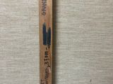 an image of a wooden ruler with writing on it on a wall