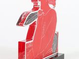 sculpture of a man sitting on a bench with a book in his hand