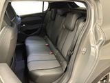 the back seat of a car with the door open and the passenger seat folded down