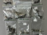 several bags of assorted items are displayed on a wall