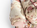 an image of a bed with a pink and white comforter on top of it