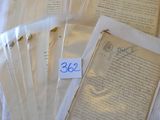 a lot of old papers that are on a bed