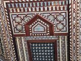 a close up of a wooden table with many designs on it