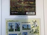 a picture of a postcard with a picture of a windmill and a bridge
