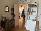 a living room with a chair and a book shelf in it