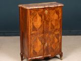 an antique chest of drawers with a marble top