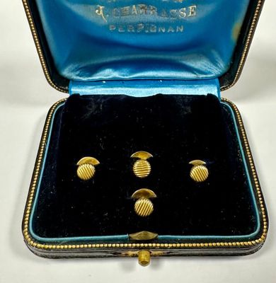 an image of a pair of gold cuff earrings in a blue case