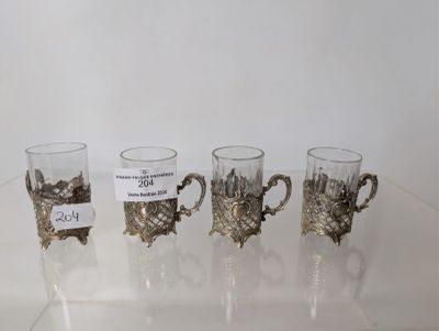 four cups that are sitting on a glass table