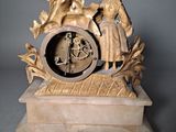 a statue of a man and a woman on a clock