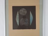 framed photograph of a black and white abstract painting on a white wall