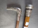 a silver cane and a silver cane on a table