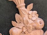 a wooden sculpture of a bird with a vase on it ' s head