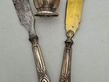 two knives and a bowl on a table