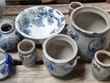 many blue and white vases sitting on a wooden table
