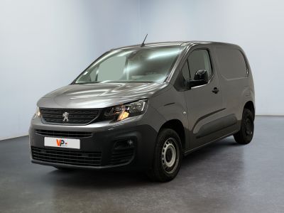 the grey van is parked in a large room with a black floor