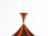 an image of a copper colored pendant light hanging from a ceiling